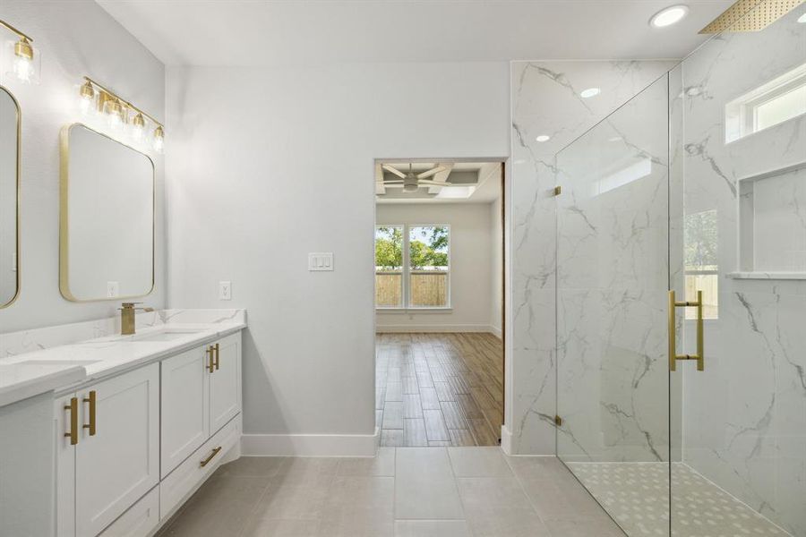 Bathroom featuring vanity, tile patterned floors, and walk in shower