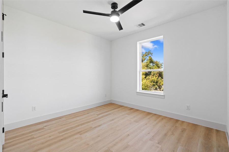 A serene secondary guest suite, complete with a walk-in closet, ceiling fan & an ensuite designed for privacy & comfort. A serene secondary guest suite, complete with a walk-in closet, ceiling fan & an ensuite designed for privacy & comfort.