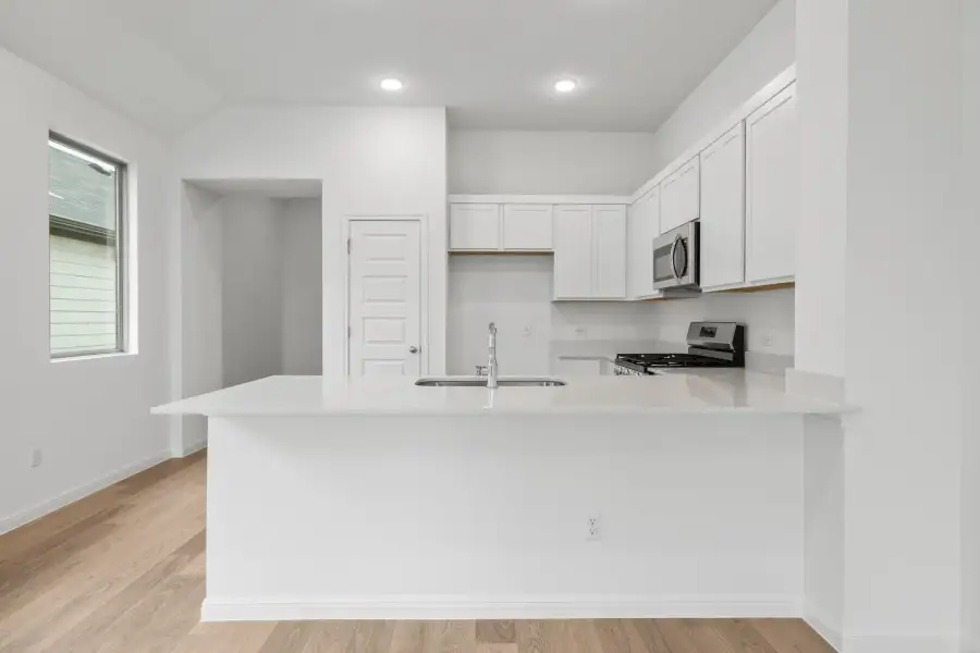 Kitchen in the Birch home plan by Trophy Signature Homes – REPRESENTATIVE PHOTO