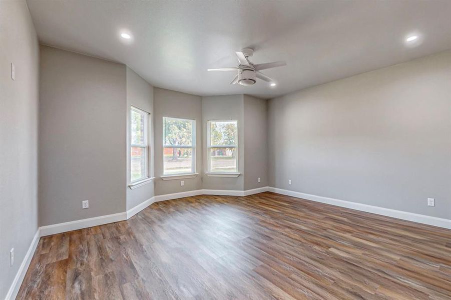 Unfurnished room featuring ceiling fan and hardwood / wood-style flooring