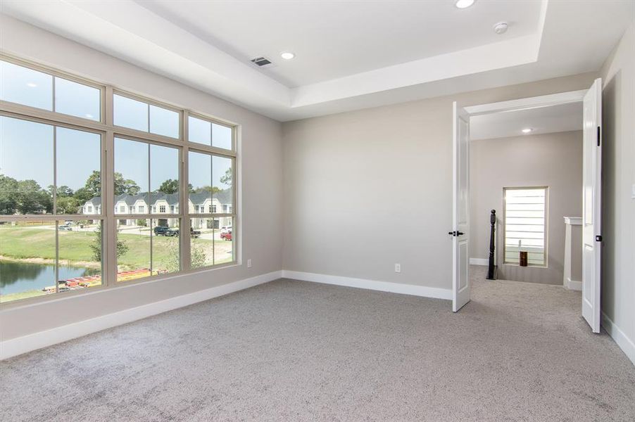 Primary bedroom with a view of the lake.