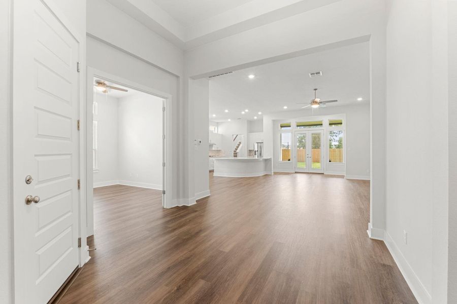 Unfurnished living room featuring a ceiling fan, dark wood finished floors, baseboards, and recessed lighting Unfurnished living room featuring a ceiling fan, dark wood finished floors, baseboards, and recessed lighting