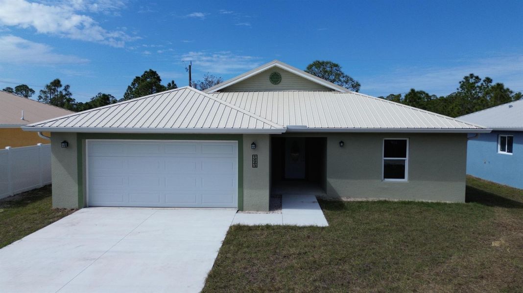 Front exterior of a new home in , Punta Gorda, FL, highlighting curb appeal (Image 1).