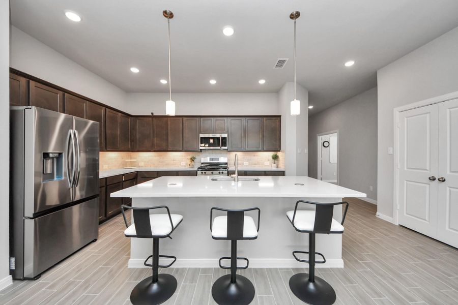 Kitchen view with plenty of cabinets and storage.  Notice double door kitchen pantry to the right.