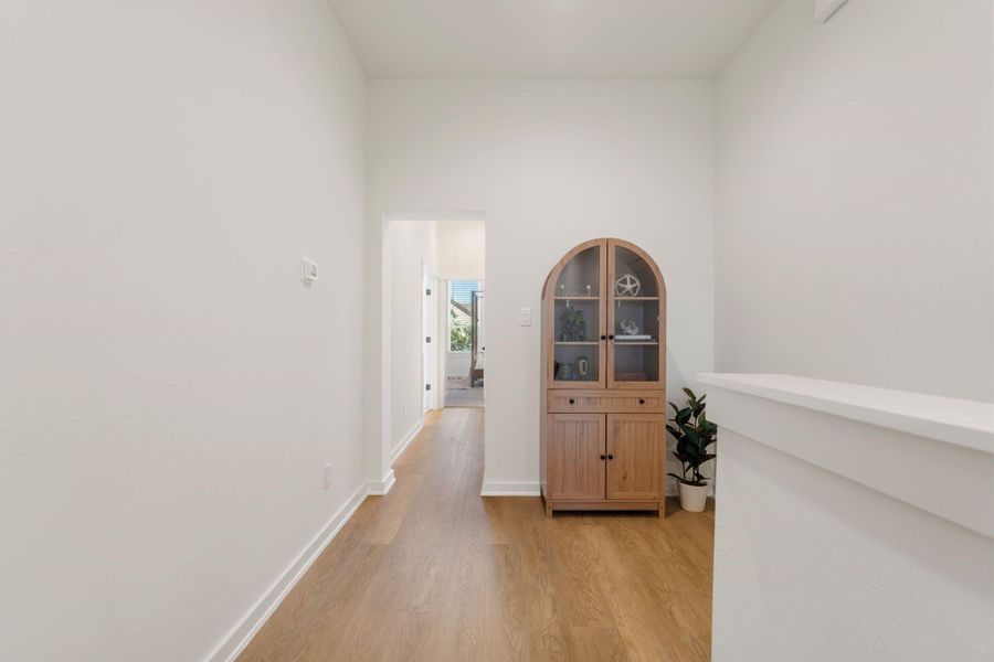 Second-floor landing offers a versatile space perfect for a home office or study area.