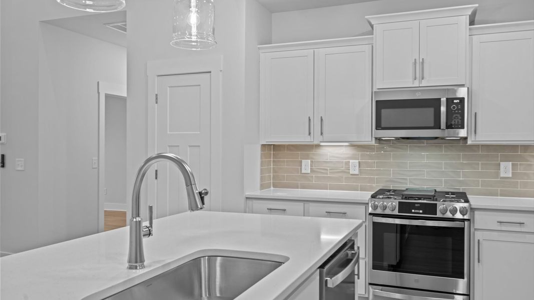 Exclusive kitchen design with large island, pendant lights, and tasteful finishes throughout