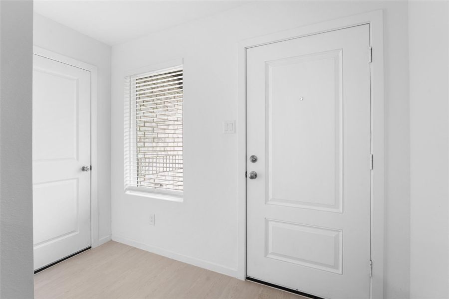 Front door conveniently located beside the garage entry for multiple ways to enter the home.