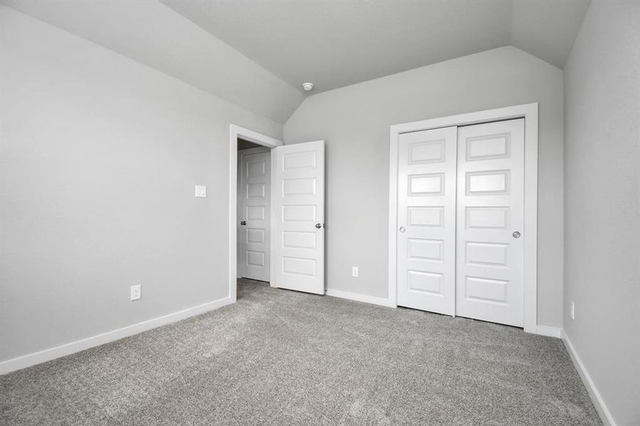 Generously sized secondary bedrooms featuring spacious closets, soft and inviting carpeting underfoot, large windows allowing plenty of natural light, and the added touch of privacy blinds for your personal retreat.