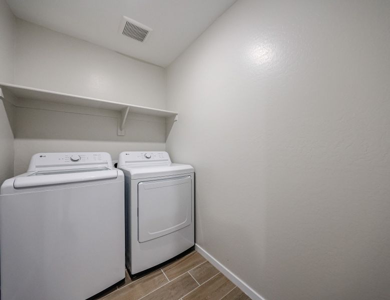 A washing machine in a room.
