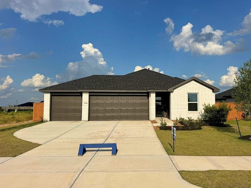 Front exterior of a new home in Sunterra Lakes, Brookshire, TX, highlighting curb appeal (Image 19). Front exterior of a new home in Sunterra Lakes, Brookshire, TX, highlighting curb appeal (Image 19).