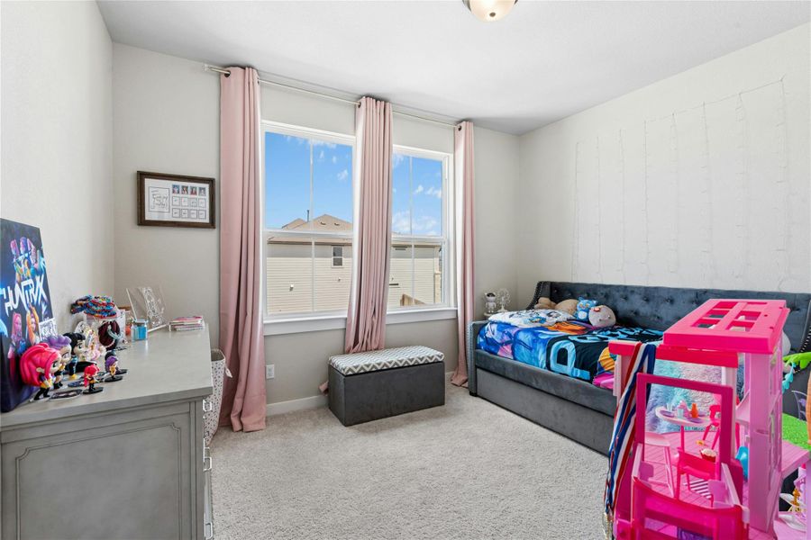 Bedroom featuring light colored carpet and baseboards