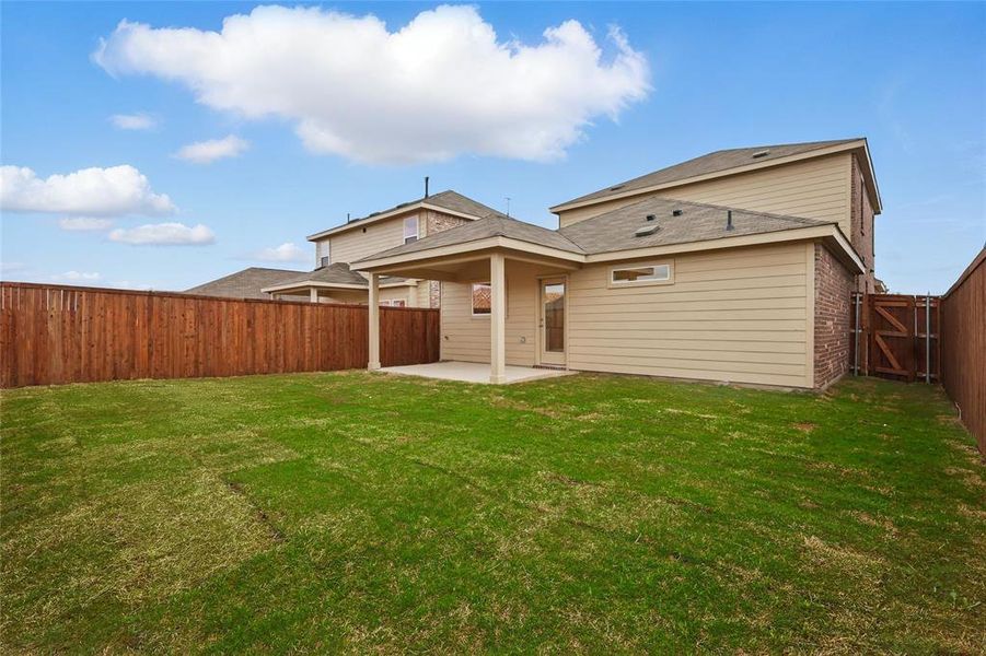 Back of house with a patio, brick siding, a lawn, and a fenced backyard Back of house with a patio, brick siding, a lawn, and a fenced backyard