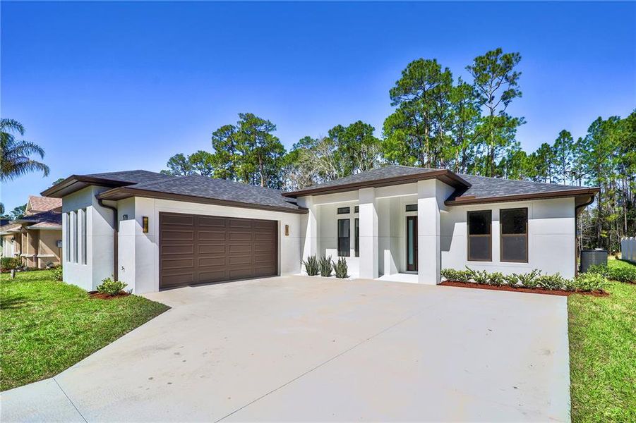 Front exterior of a new home in , Palm Coast, FL, highlighting curb appeal (Image 28). Front exterior of a new home in , Palm Coast, FL, highlighting curb appeal (Image 28).