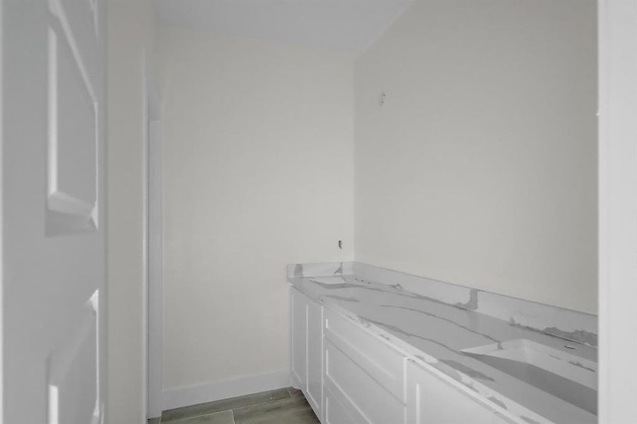 Featuring a spacious vanity with plenty of storage, sleek countertops, and modern fixtures, this bathroom is both practical and beautiful.