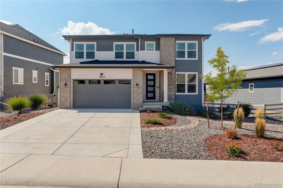 Front exterior of a new home in , Littleton, CO, highlighting curb appeal (Image 21).