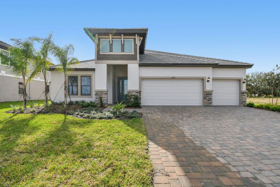 Front exterior of a new home in River Preserve Estates, Parrish, FL, highlighting curb appeal (Image 32).