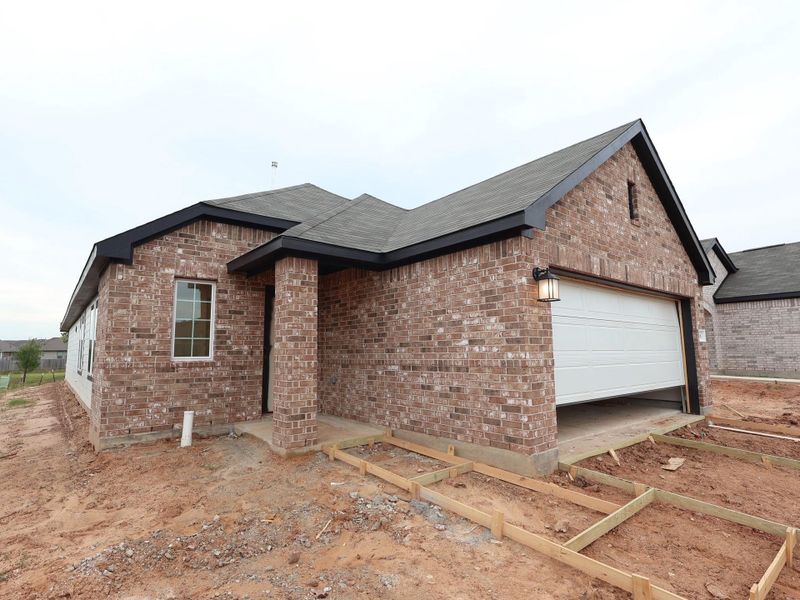 Front exterior of a new home in Magnolia Ridge, Magnolia, TX, highlighting curb appeal (Image 18). Front exterior of a new home in Magnolia Ridge, Magnolia, TX, highlighting curb appeal (Image 18).