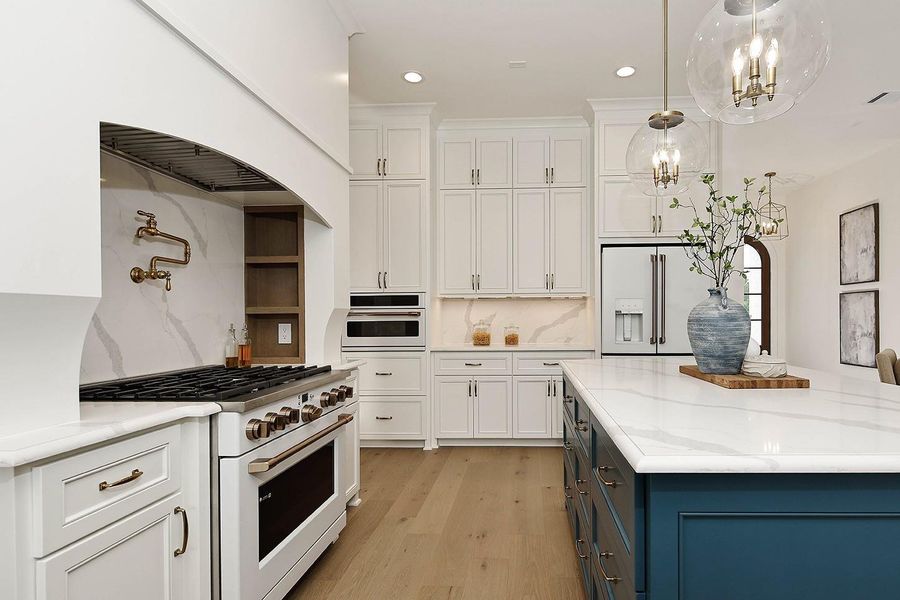 The finest custom cabinetry extends to ceiling for additional storage, and a convenient built in GE cafe microwave oven.