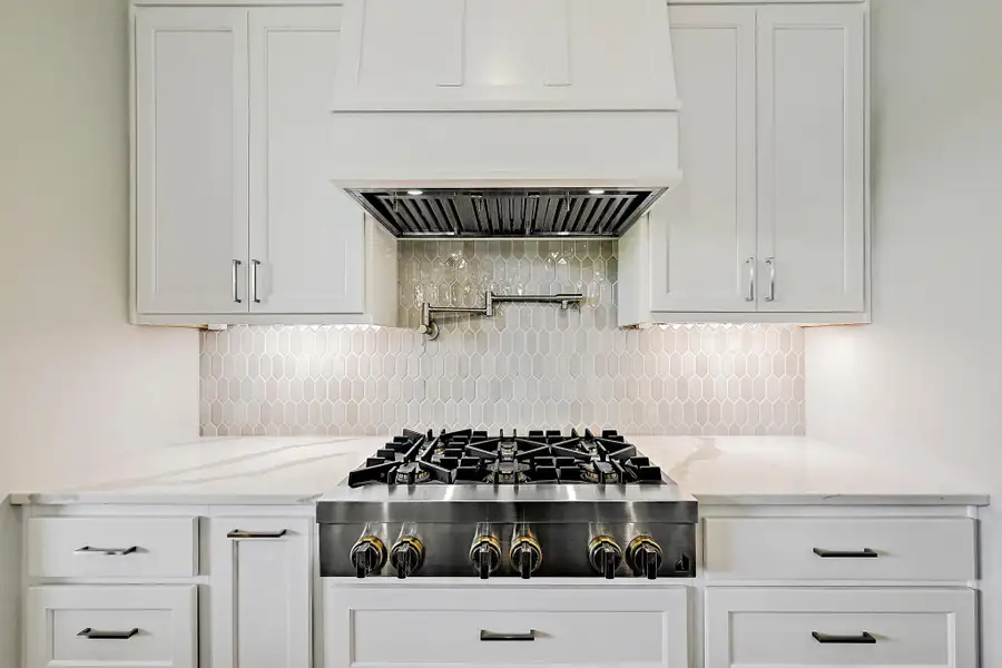 A well-appointed kitchen showcasing a sleek gas cook-top and contemporary cabinetry.