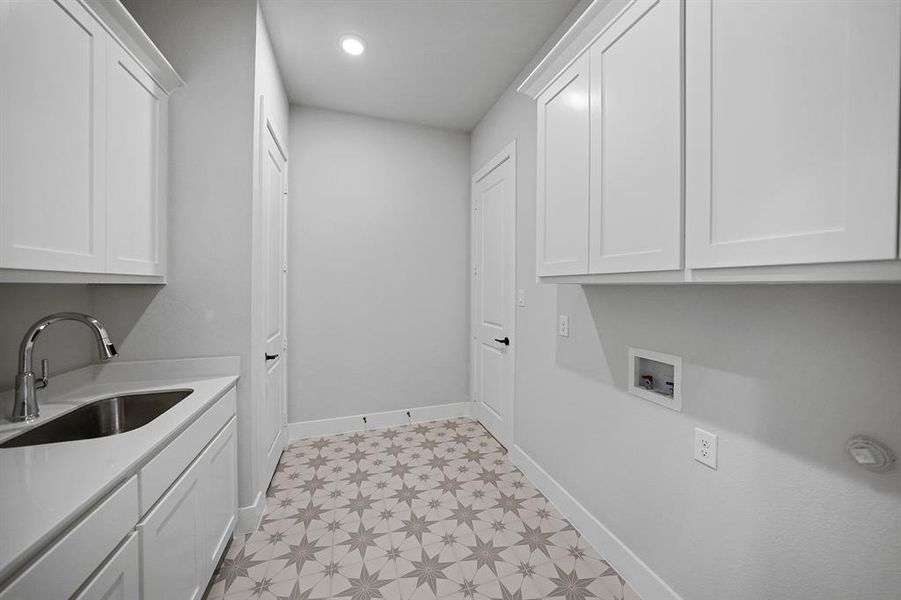 Laundry room featuring cabinet space, washer hookup, light flooring, and recessed lighting Laundry room featuring cabinet space, washer hookup, light flooring, and recessed lighting
