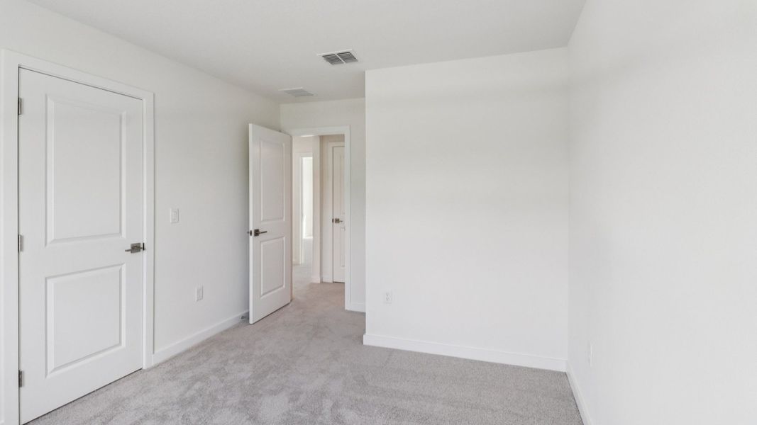 Guest Bedroom in the Monterey End Townhome by DRB Homes - Cyrene at Harmony in St Cloud FL