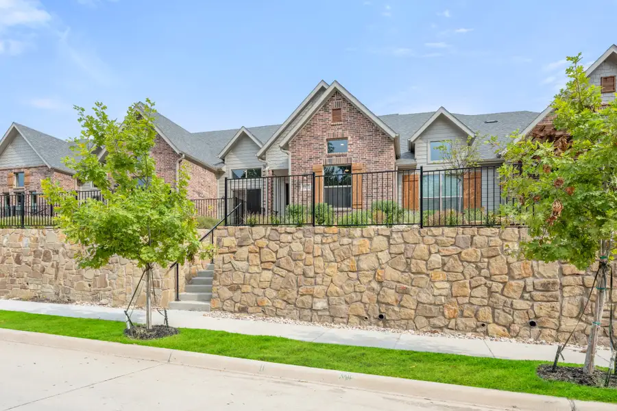 Front exterior of a new home in Cottonwood Creek, Rowlett, TX, highlighting curb appeal (Image 27).