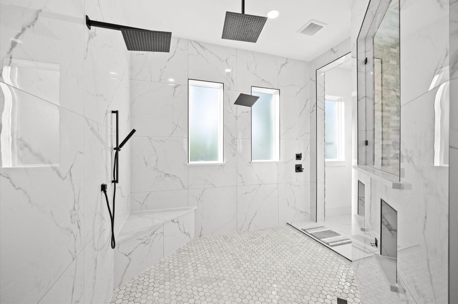 Oversized walk-in shower with premium tile finishes.