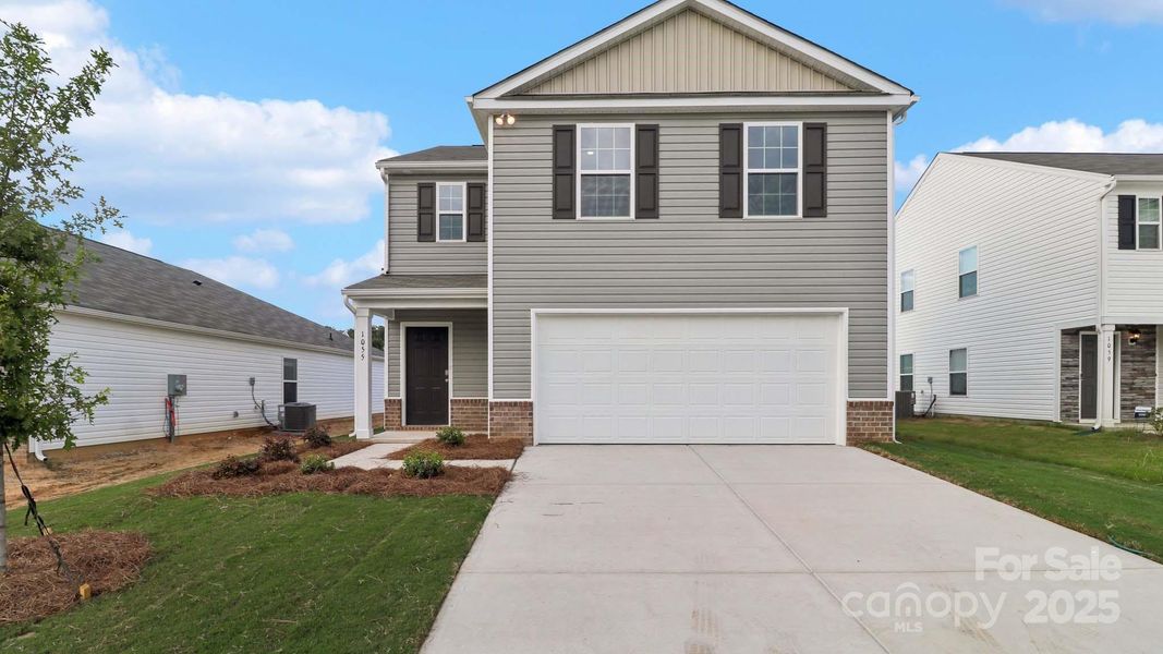 Front exterior of a new home in Woodhaven at Chester, Chester, SC, highlighting curb appeal (Image 1).