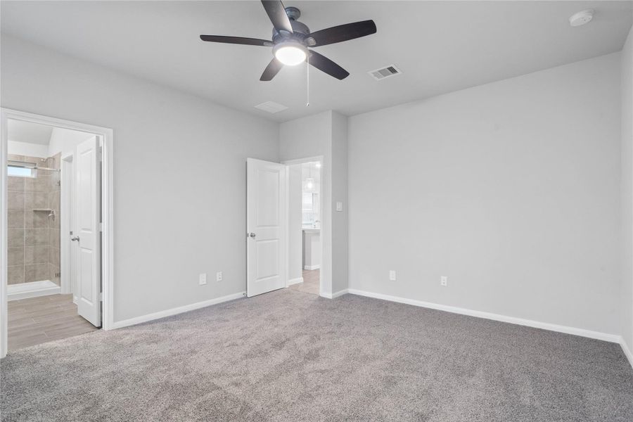 The private primary suite efficiently connects the sleeping area with the dedicated bathroom and generous closet.