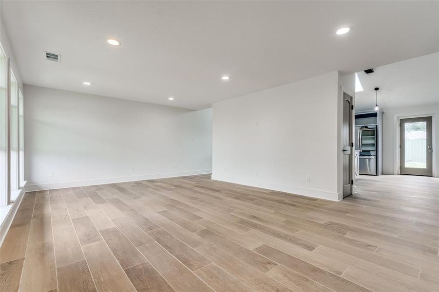 Open concept living room showing to paths back to the stunning kitchen and dining areas.