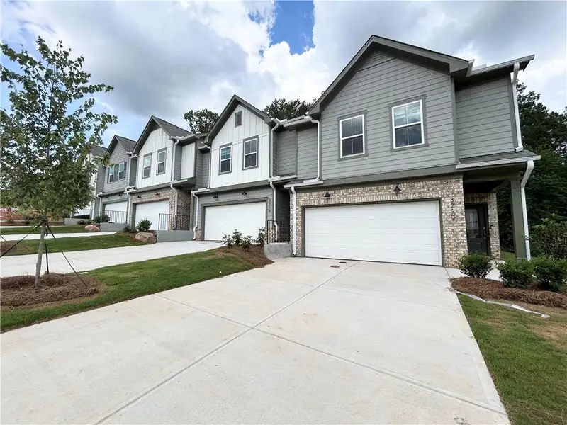 Front exterior of a new home in Ansley Towns, Cumming, GA, highlighting curb appeal (Image 1). Front exterior of a new home in Ansley Towns, Cumming, GA, highlighting curb appeal (Image 1).
