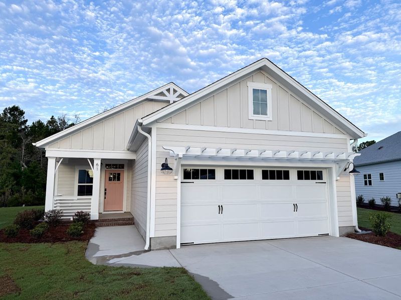 Front exterior of a new home in Songbird, Hampstead, NC, highlighting curb appeal (Image 1). Front exterior of a new home in Songbird, Hampstead, NC, highlighting curb appeal (Image 1).