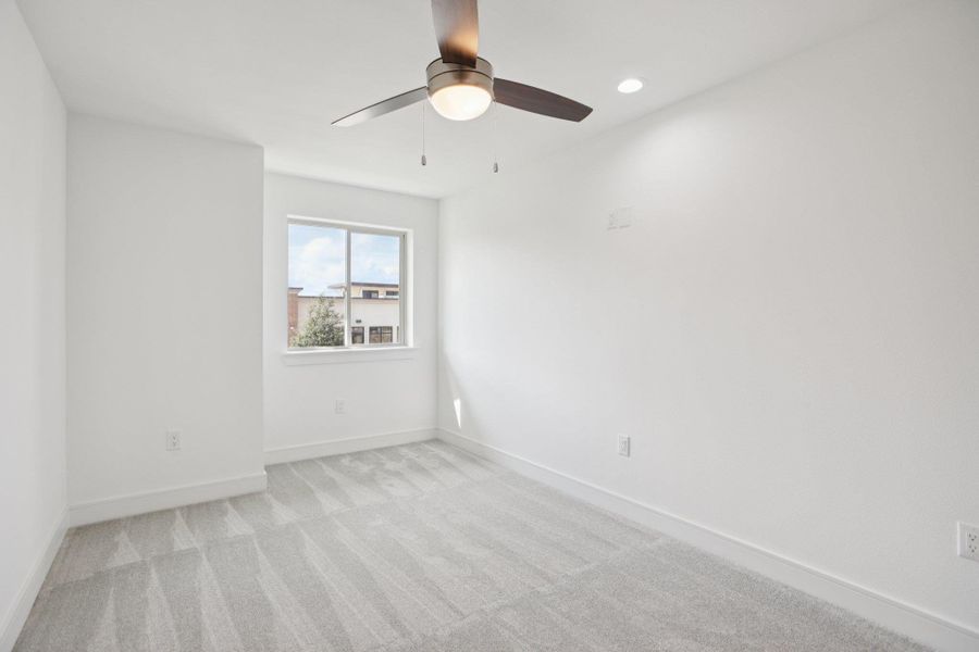 Empty room with light carpet, recessed lighting, and a ceiling fan
