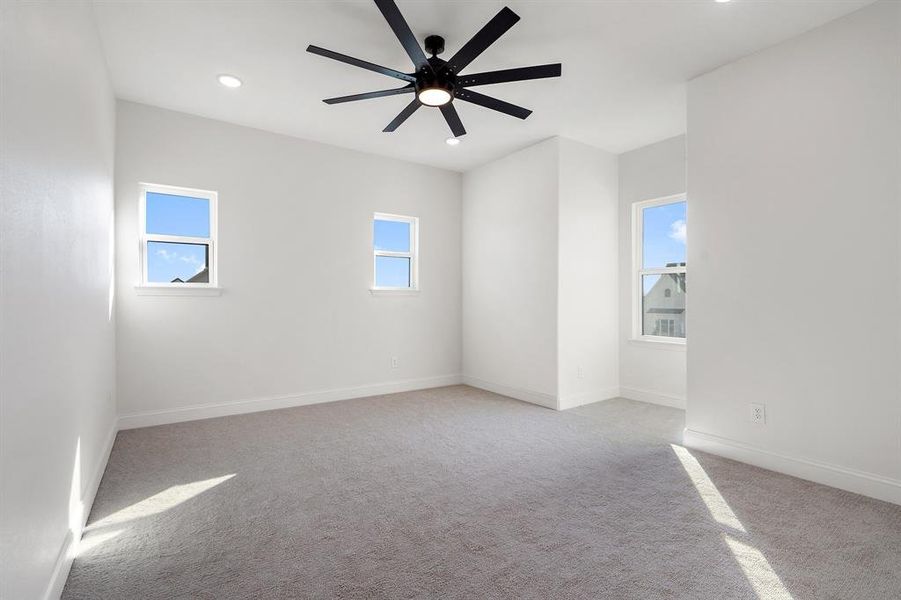 Empty room with light colored carpet, recessed lighting, and ceiling fan Empty room with light colored carpet, recessed lighting, and ceiling fan