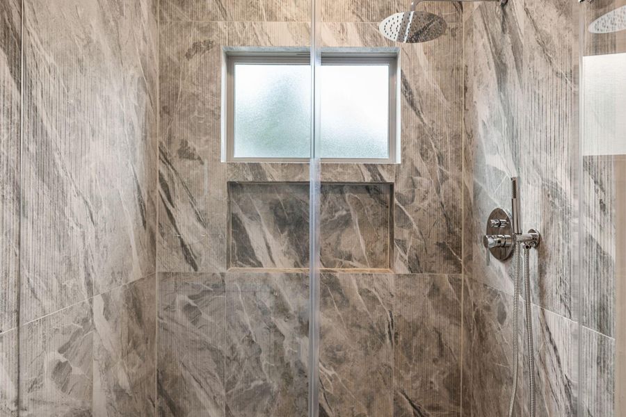 Statement shower tile in a secondary bathroom upstairs, located off the sauna. Statement shower tile in a secondary bathroom upstairs, located off the sauna.
