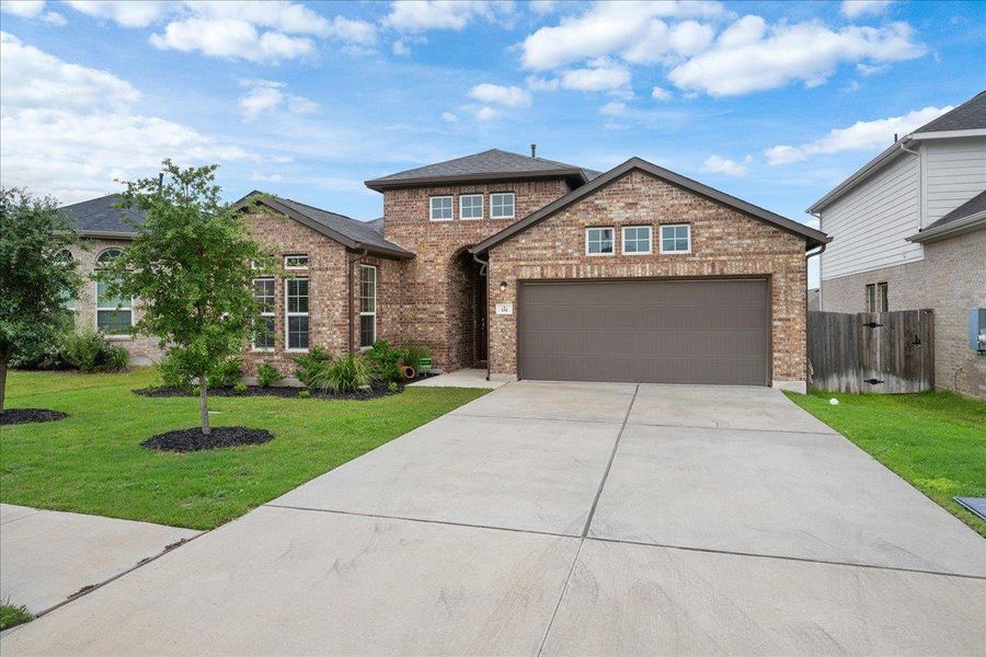 View of front of house featuring brick siding, driveway, and a garage View of front of house featuring brick siding, driveway, and a garage