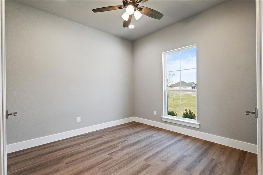 Office with an inviting chandelier, a wealth of natural light, and light hardwood / wood-style floors