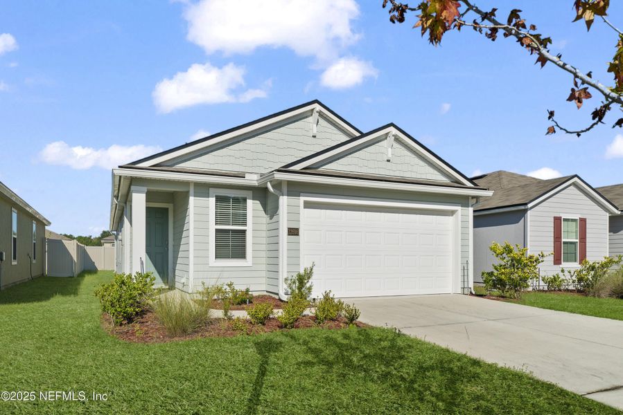 Front exterior of a new home in The Arbors, Jacksonville, FL, highlighting curb appeal (Image 1). Front exterior of a new home in The Arbors, Jacksonville, FL, highlighting curb appeal (Image 1).