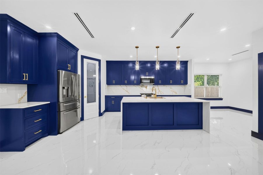 Striking kitchen with bold cabinetry, expansive island and bright contemporary finishes
