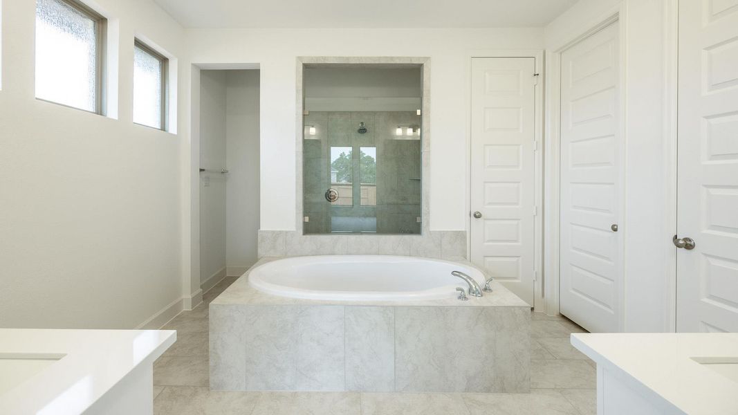 Full bath with vanity, baseboards, tile patterned floors, a bath, and a shower stall Full bath with vanity, baseboards, tile patterned floors, a bath, and a shower stall