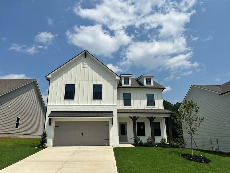 Front exterior of a new home in Summerlin, Winder, GA, highlighting curb appeal (Image 23). Front exterior of a new home in Summerlin, Winder, GA, highlighting curb appeal (Image 23).