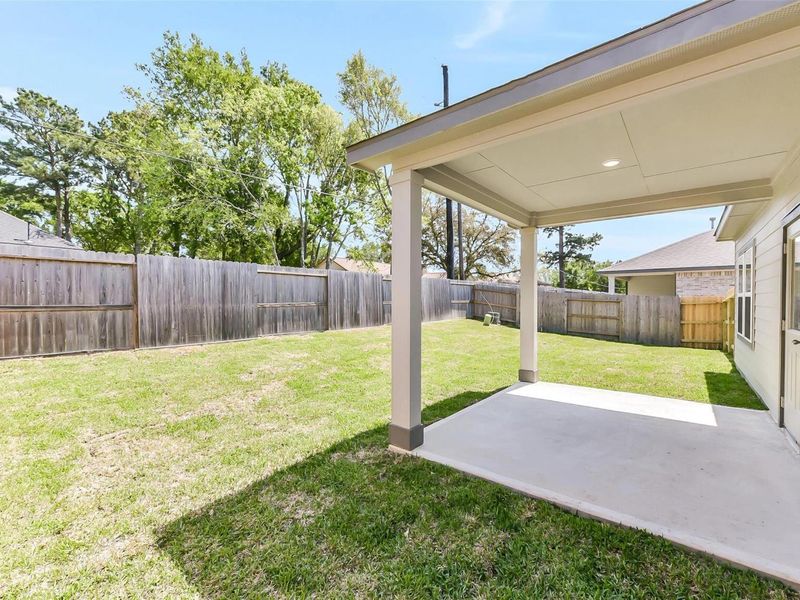 Exterior details and patio area of a home in Windmill Estates, Magnolia (Image 28).