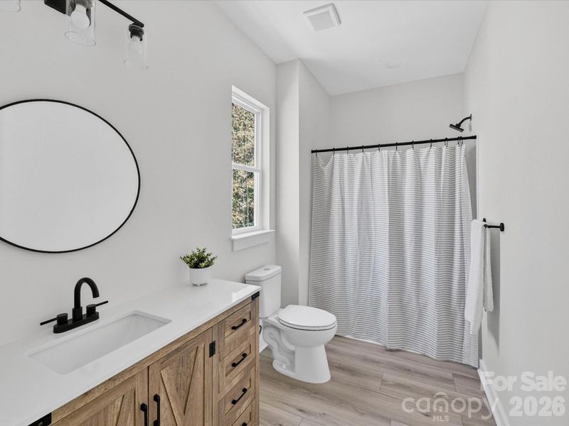 Stylish Jack-and-Jill bathroom showcases modern finishes, dual vanities, and a thoughtfully designed layout that seamlessly connects adjoining bedrooms for both convenience and privacy.