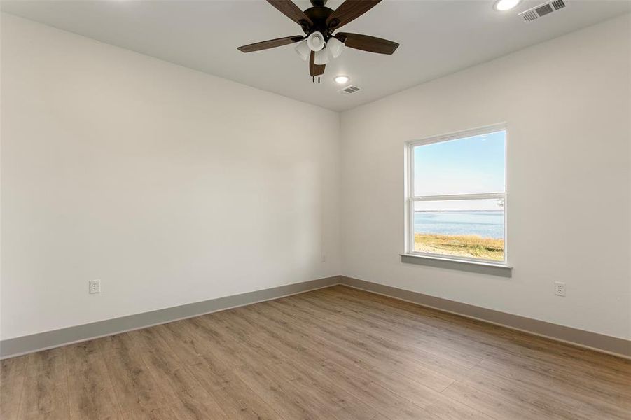 Unfurnished room featuring ceiling fan and light hardwood / wood-style floors