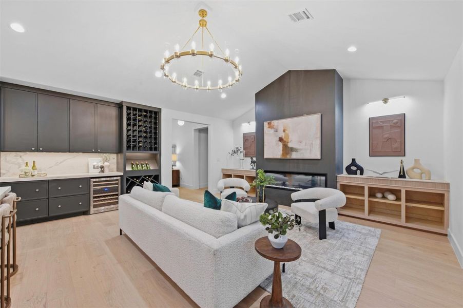 Smoky-toned porcelain slab fireplace wall creates a dramatic focal point, with a bumped-out design and gas fireplace adding depth, warmth, and architectural interest to the living room.