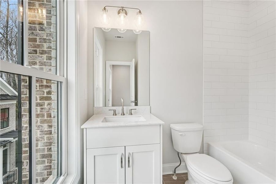 Bathroom featuring vanity and tub / shower combination