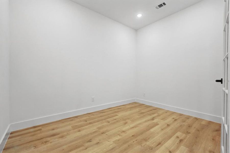 Unfurnished room featuring baseboards, light wood-style flooring, and recessed lighting
