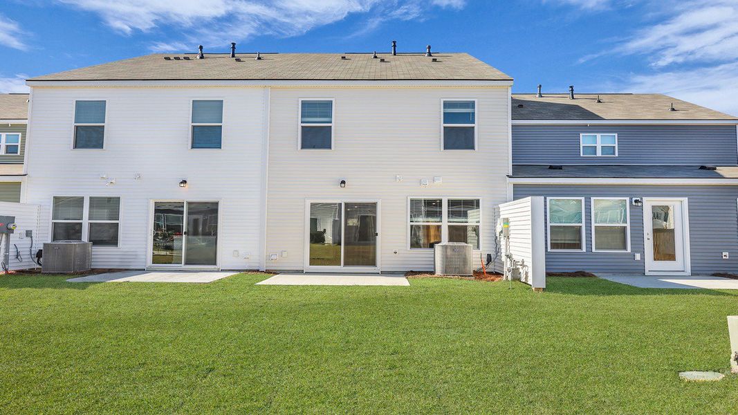 Exterior details and patio area of a home in Pine Hills Townhomes at Cane Bay, Summerville (Image 4). Exterior details and patio area of a home in Pine Hills Townhomes at Cane Bay, Summerville (Image 4).
