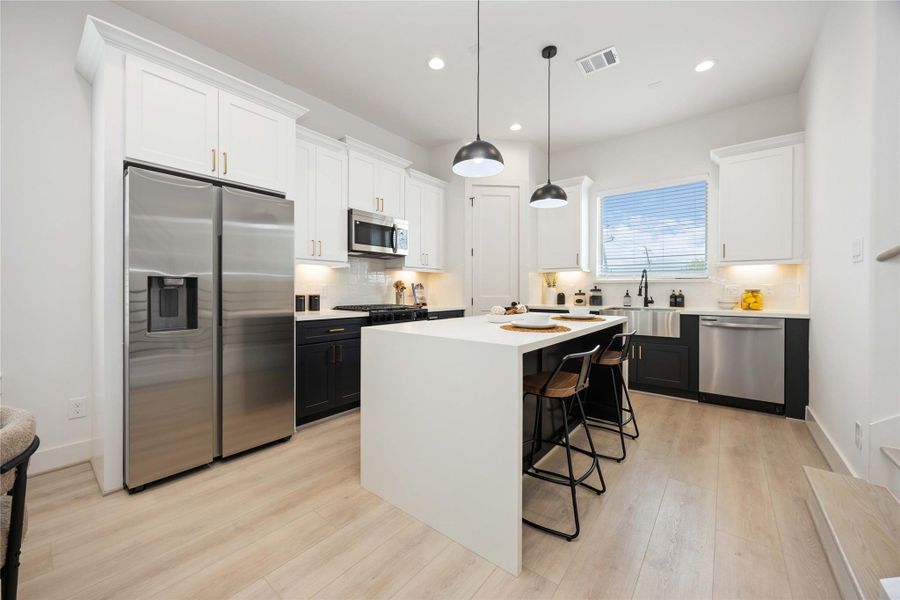 Island kitchen. Photo of the model home. Finishes & specifications may vary.