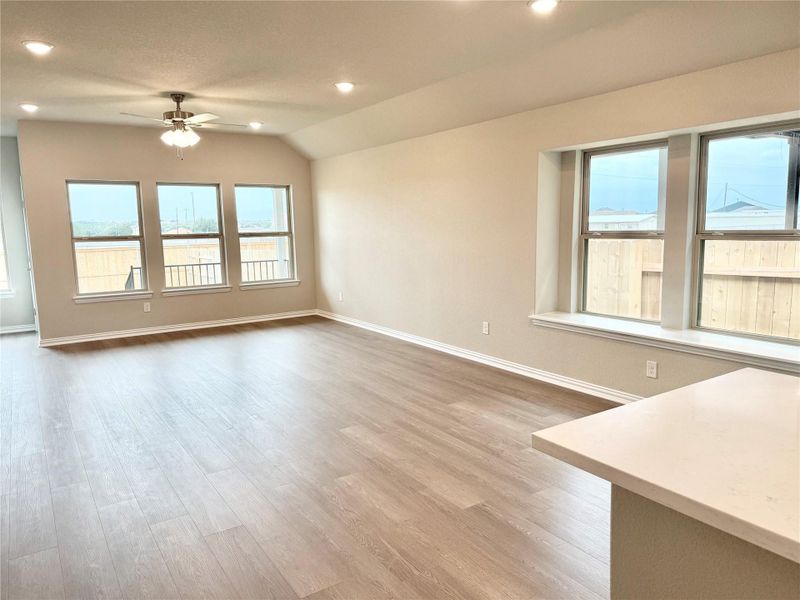Unfurnished living room with recessed lighting, plenty of natural light, light wood-style floors, ceiling fan, and vaulted ceiling Unfurnished living room with recessed lighting, plenty of natural light, light wood-style floors, ceiling fan, and vaulted ceiling